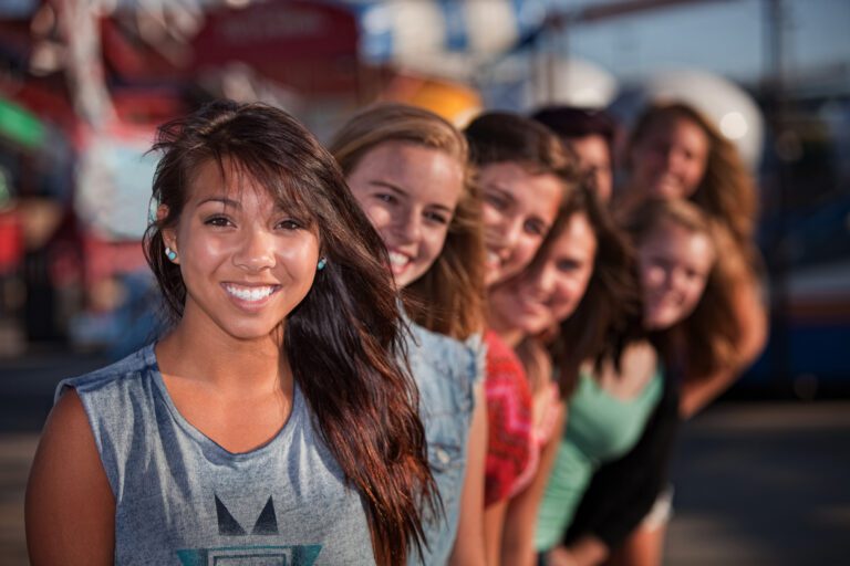 Row of Cute Girls at Theme Park.
